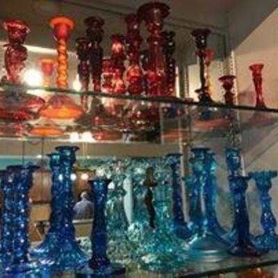 Lots of colored glass candlestick holders. Depression era.