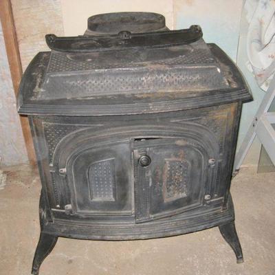 Wood burning stove with pipes.
