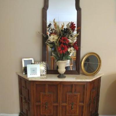 Marble top console, picture frames and florals.
