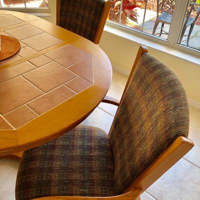 Oval Wood Pedestal Tile Top Dinette Set with One Leaf and Four Upholstered Chairs on Wheels  (Table 42"W  61"L  30"H)...
