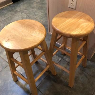Two light wood bar stools