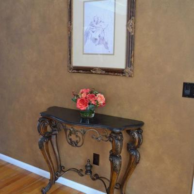 Console table and framed artwork
