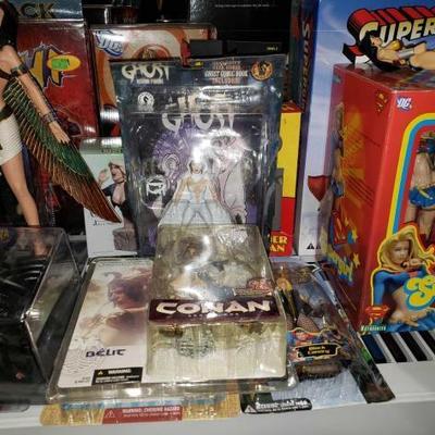 #1056: Comic Book Action Figures and Statues. Supergirl, Conan, Black Canary, and More
Also includes diecast Batmobile and other figures...