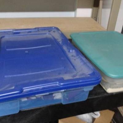 2 Storage containers with lids and fabric.