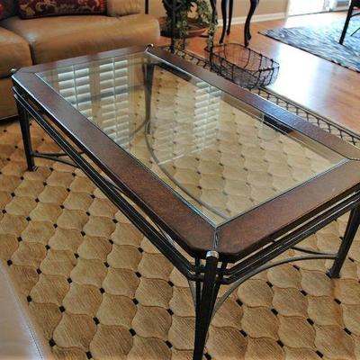 Glass top coffee table with wrought iron base.  50