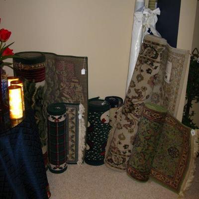 Assortment of area rugs and carpets.  some Christmas 