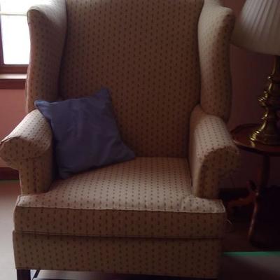 Ethan Allen wing back chair.  
The background is tan and the design is tiny rust and blue