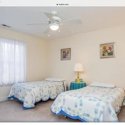 2 twin beds with bed frame, 2 side tables with skirts, 2 lamps.  Located on second floor.