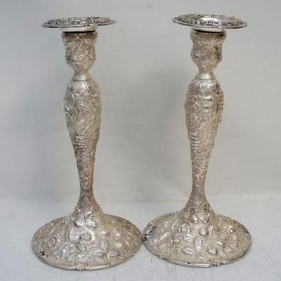 Cincinnati, late 19th-early 20th century. A pair of sterling silver repousse and chased candlesticks of baluster form, decorated with...