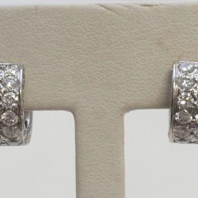 Pair of stunning huggie style earrings. Each earring features a total of thirty-six (36), pave set, round brilliant cut dimaonds for a...