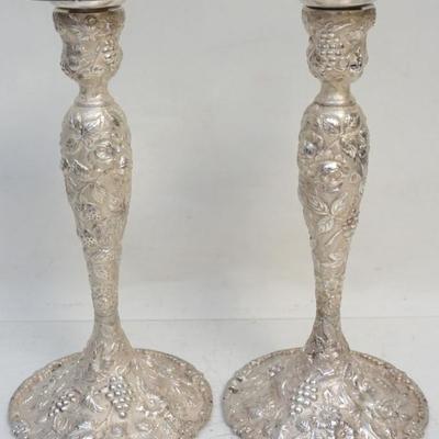 Cincinnati, late 19th-early 20th century. A pair of sterling silver repousse and chased candlesticks of baluster form, decorated with...