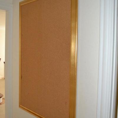 One of a pair of gold framed bulletin board