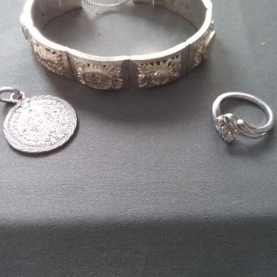Silver Bracelet, Silver Medallion, and Silver Ring
