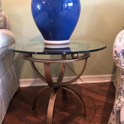 Two 'hourglass' metal base glass-top tables.
