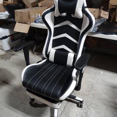 White and black gaming chair with foot rest.