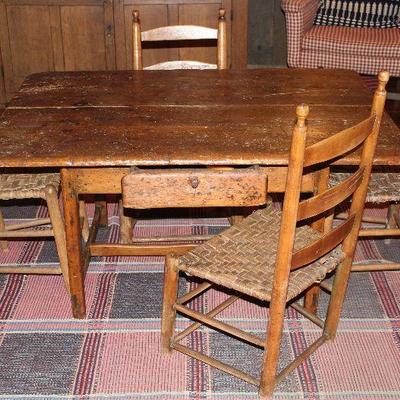 Another view of Antique 1700’s Cape Cod Tavern Table Shown with 4 Various Styles of Antique Slat/Ladder Back Cane Bottom Chairs Showing...