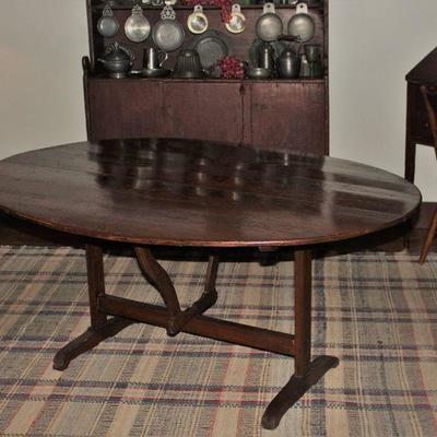 Antique 19th Century Oval Tilt-Top (60â€ x 44â€) table and tilts to a vertical position so it may be stored against a wall when not used.