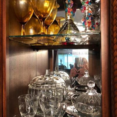 A Hutch filled with beautiful glassware and serve ware.