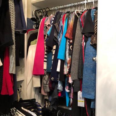 A large closet full of quality women's clothing.