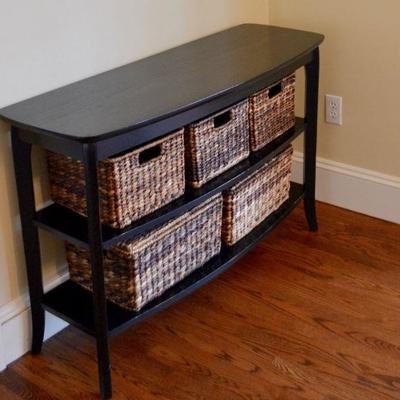 Black console table with woven storage