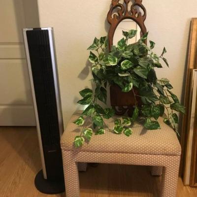 Small bench seat, tower fan, decorative wood plant holder with plant.