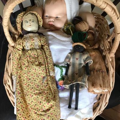 The big doll in the basket is $40 , black doll $12 , other old doll $18