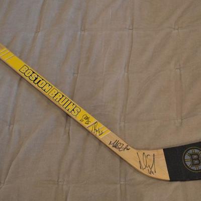 Autographed Bruins mini hockey stick, including signatures from Tuuka Rask and Brad Marchand