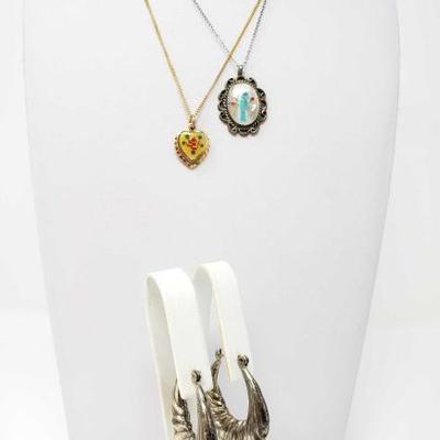 #179: Two Sterling Silver Necklaces and Pair of Earrings
Gold-colored chain is not sterling, only pendent Silver combined weighs approx...