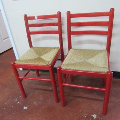 2 red painted rush seat chairs