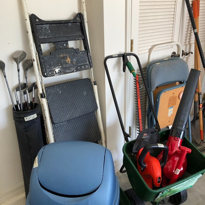 Step ladder, golf clubs, trash container