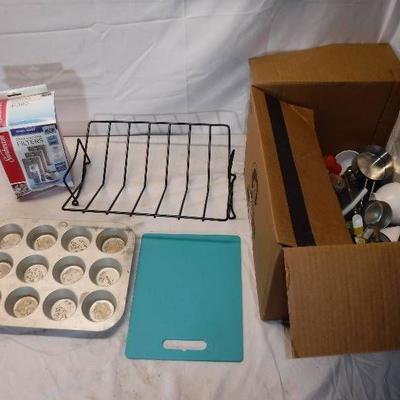 #Box full of kitchenwares, measuring cups, funnels ...