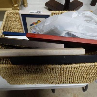 Lot of picture frames and a basket.