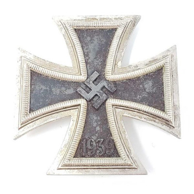 2142:
German World War II 1st Class Iron Cross
The front shows a swastika in the center of the maltese cross and is dated â€˜1939â€™ on...