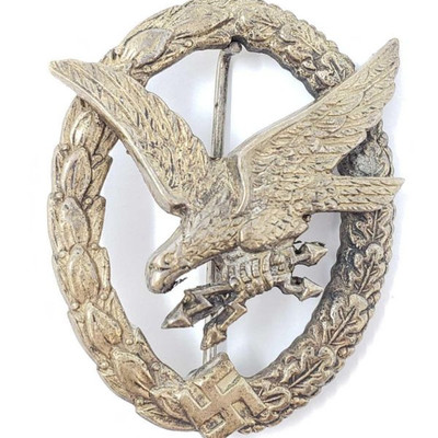 	
German World War II Luftwaffe Radio Operator Aerial Gunner Badge
The front shows a diving eagle with two lightning bolts in his talons....