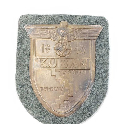 2065: 	
German World War II Army 1943 KUBAN Sleeve Shield
The front reads â€˜1943 Kuban Lagunen Krymskataâ€™. There is a German eagle...