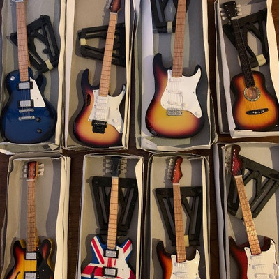 395:
Eight Handmade Mini Guitars
Each measures approx 7-10.5â€