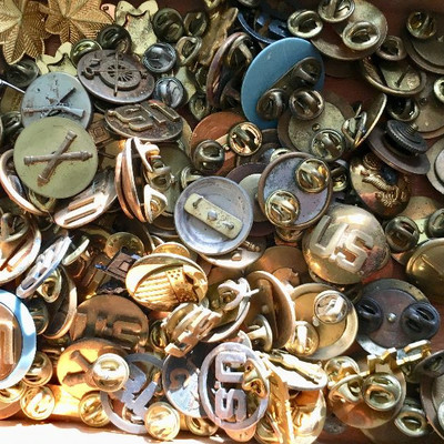 Box of pins with various insignias 