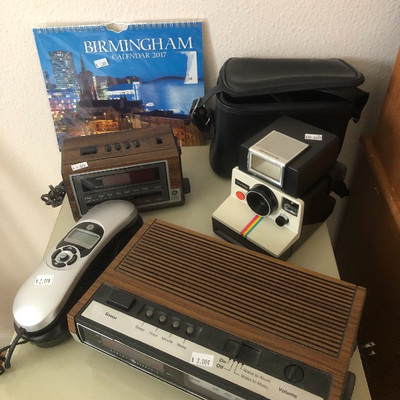 Clock radio, corded phone, Polaroid camera 