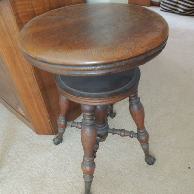 antique piano stool with glass paw feet
