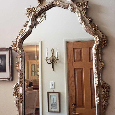 251:	
	
Beautiful ornate framed mirror has dainty daisies and foliage accents along the edges with finely carved interior fringe...