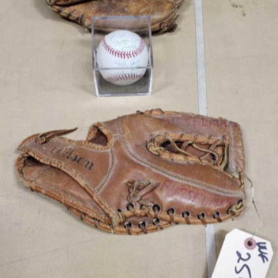 2504: 	
Signed baseball and 2 vintage baseball gloves
Signed baseball and 2 vintage baseball gloves