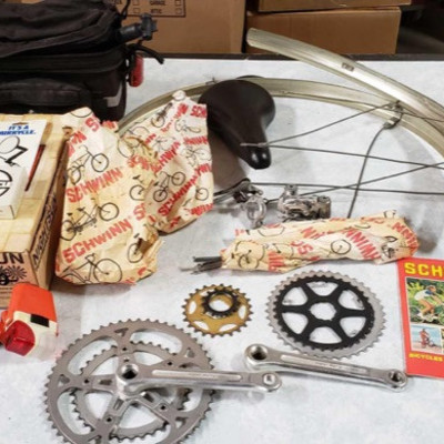 52: 	
Schwinn bike parts, catalog, bike gear, travel bag
Miscellaneous bicycle parts for Schwinn model including a 1980 Schwinn bicycle...