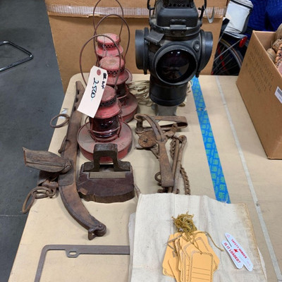2500: 	
Antique trail signal, lanterns, trap, hane, sack with tags, and volvo license plate frame
Antique trail signal, lanterns, trap,...