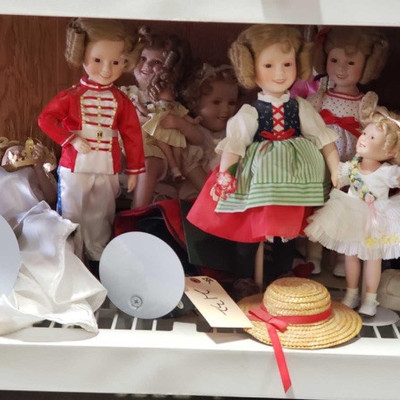 2132: 	
Shirley Temple Porcelain Doll's
These are so cute!! Here are 11 Shirley Temple collectors dolls, porcelain with stuffed fabric...