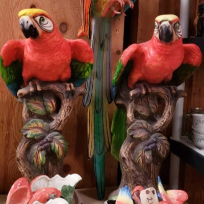 2140: 	
Nine Parrott Statues
A collection of ceramic parrot statues, figurines, flower holders and dishes. Measures approximately from...