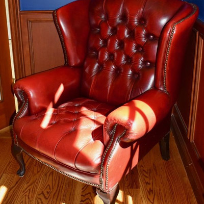 Red leather wing back chair