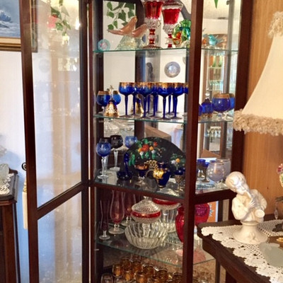 Display case with stemware and Murano glass