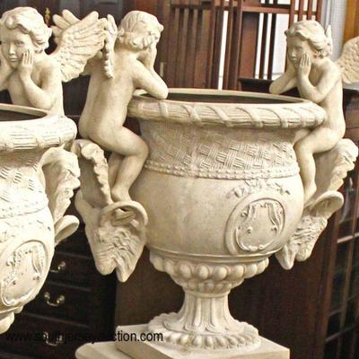  PAIR of Large 2 Piece Composition Planter Urns with Cherubs on Ram Heads

 (Approximately 5â€™ High)

Auction Estimate $500-$1000 â€“...