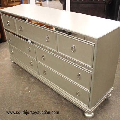  NEW Silver and Mirrored Accent Decorator 7 Drawer Dresser on Bun Feet

Located Inside â€“ Auction Estimate $200-$400

  