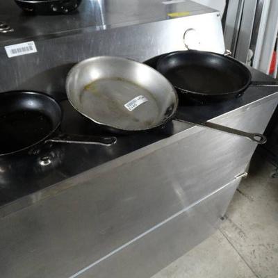 3 frying pans.